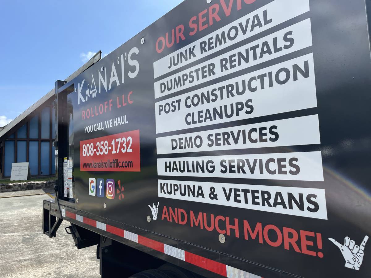 Side of a Kana'i's Junk Removal truck listing our services.