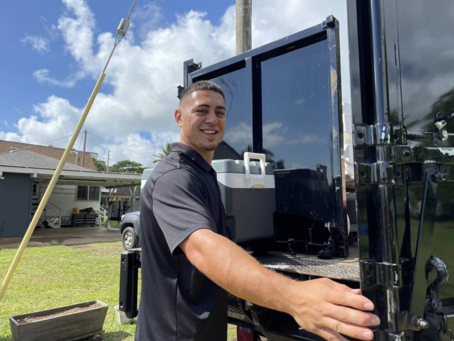 kana'i's roll off owner closing truck doors after removing old mattress and preparing to recycle mattress