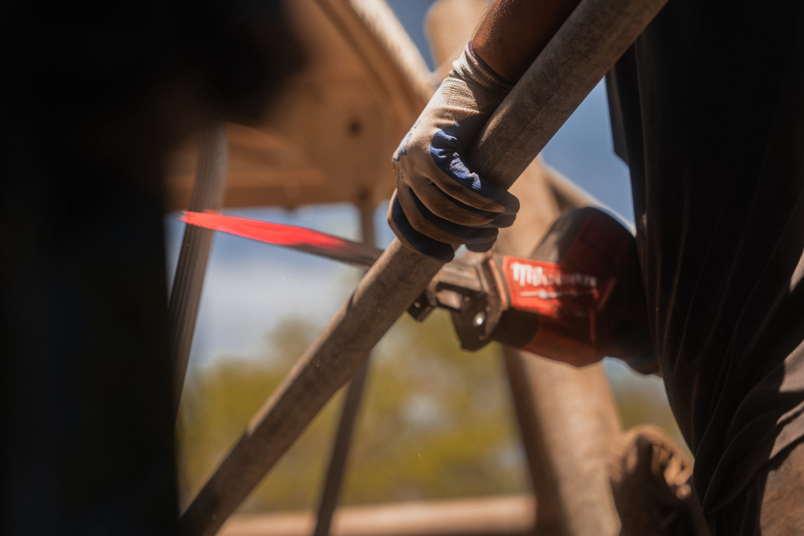 Our demolition specialist is cutting a steel pipe with a sawzall.