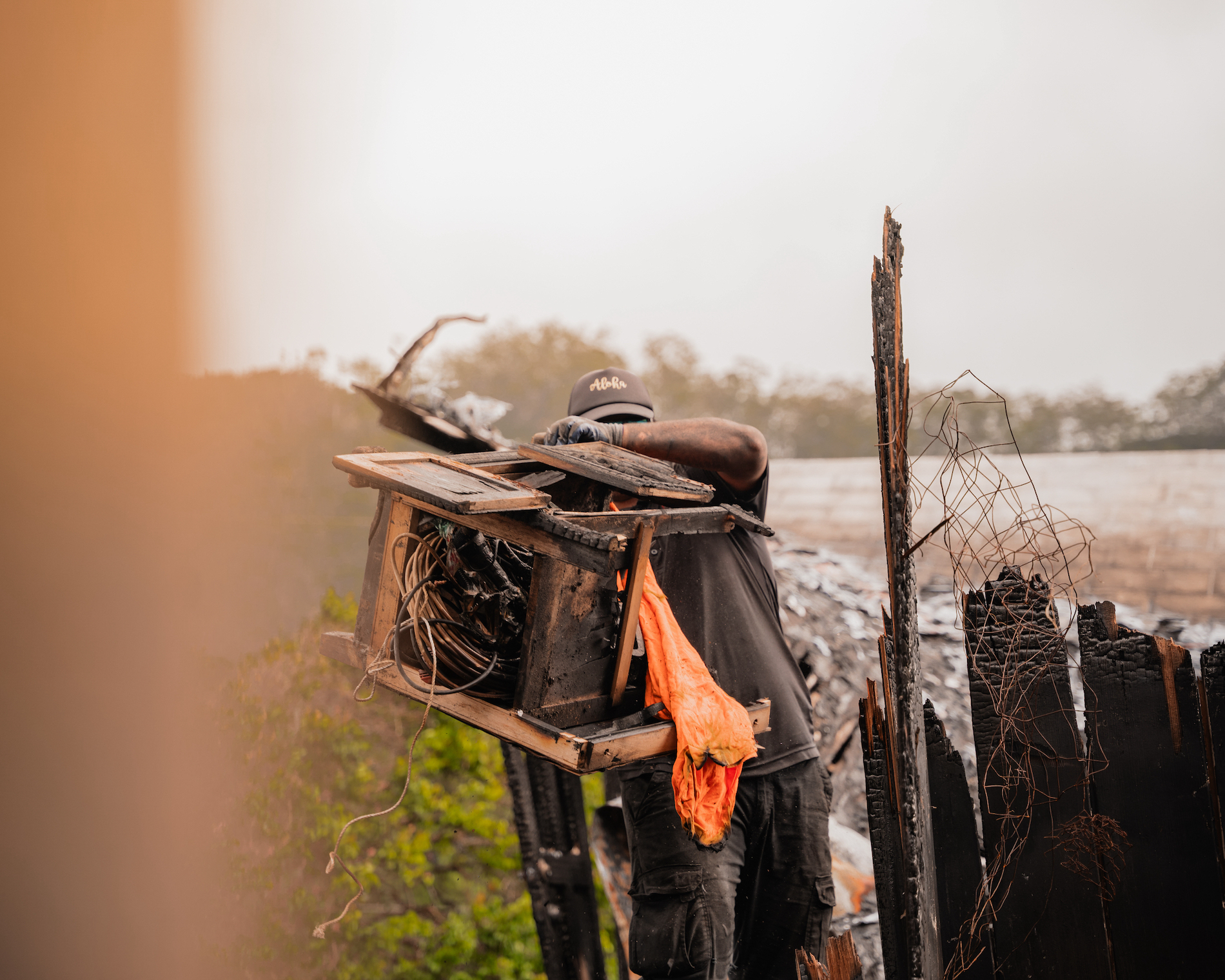 A junk removal tech from our staff is carrying a rotten old chair for a customer in Kapolei, Oahu.